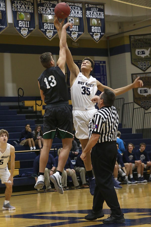 To start the game, freshman Keeshawn Mason jumps for the tipoff. 