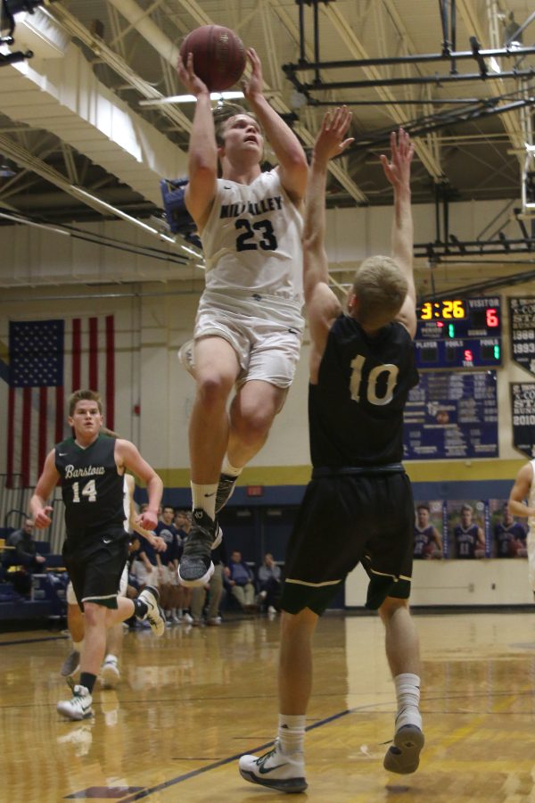 Jumping above his defender, senior Cooper Kaifes attempts a layup.