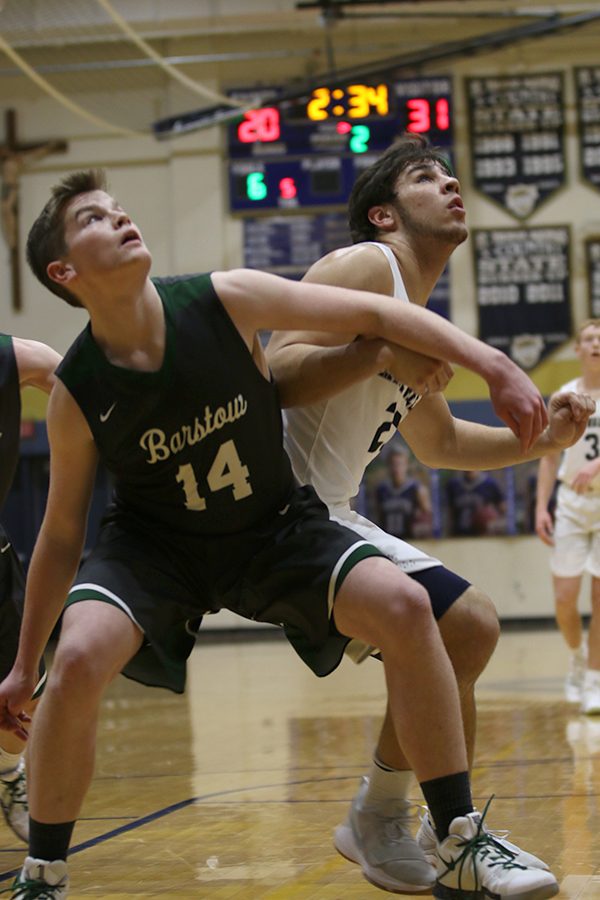 Following a free throw, senior Ike Valencia fights against his opponent to get the rebound.