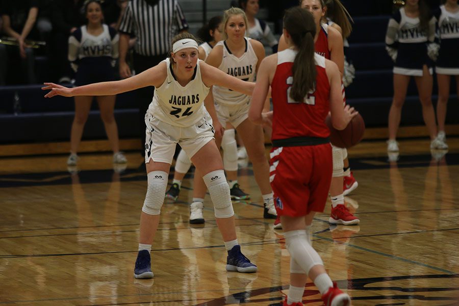 Standing with her arms stretched out, senior Evan Zars attempts to block the Stags on Friday, Jan. 5.