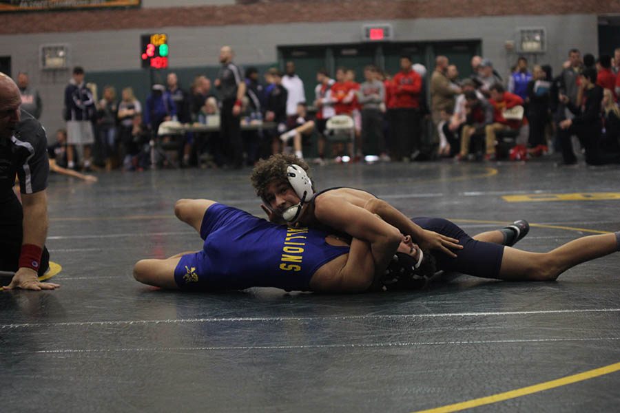 Sophomore Zach Keal keeps his opponent pinned down.
