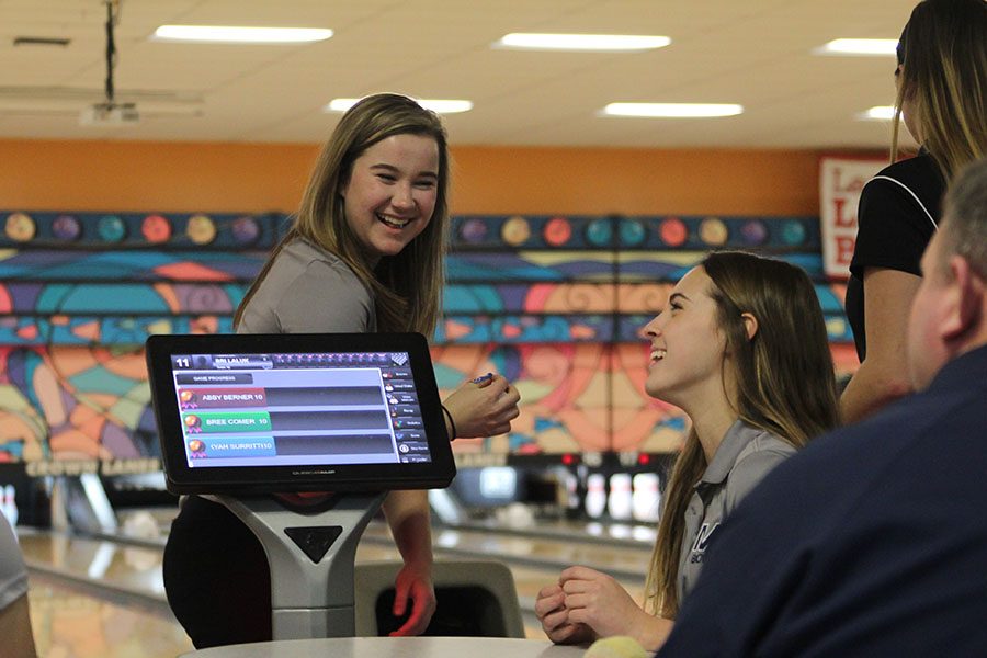 In between frames, sophomore Bri Laluk and senior Emily Jackson bond at the Crown Lanes bowling tournament on Tuesday, Feb. 6.