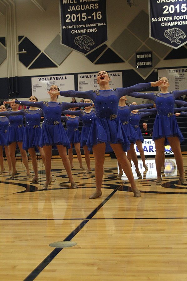 At halftime of the game, senior Emmy Bidnick performs with the Silver Stars dance team.