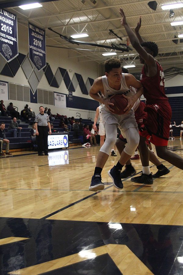 Attempting to get past a Washington defender, freshman Keeshawn Mason attempts to shoot the ball. 