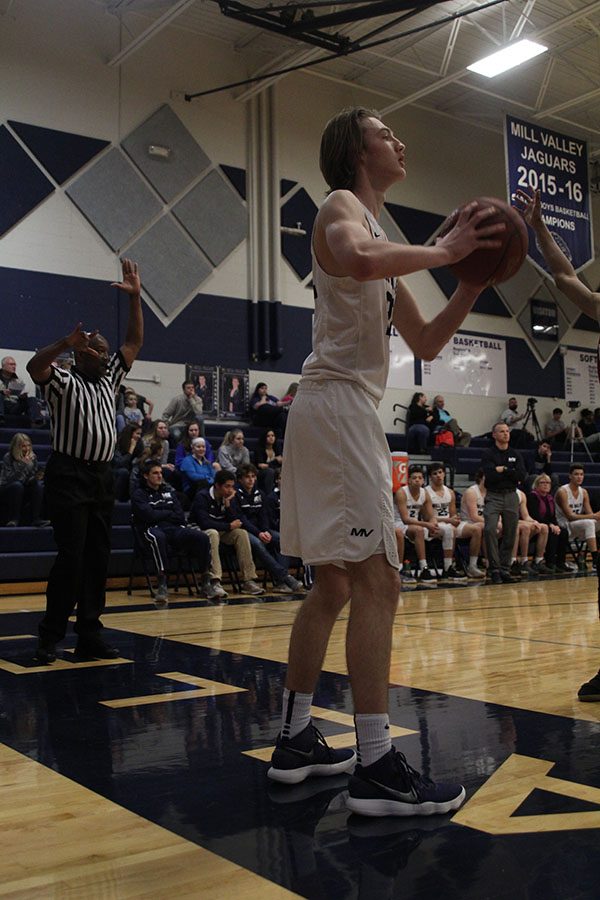 Looking for a teammate to pass to, senior Ben Weigel holds the ball to his chest. 