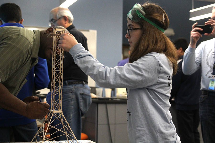 While showing the specifications of her tower, sophomore Eva Burke competes in the Tower event at the Science Olympiad regional competition at Johnson County Community College on Saturday, Feb. 24.