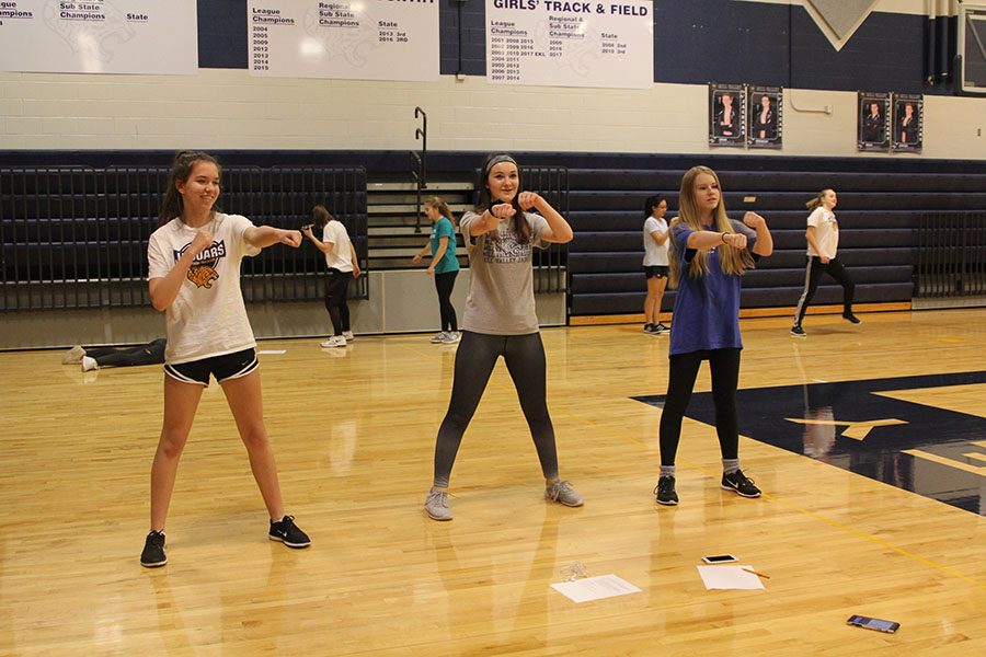 During fourth block on silver day, freshmen Tatum Elliot, Kylie Overbaugh and Ella Greenup begin trying different moves to use for their aerobic dance routine on Monday, Feb. 5.