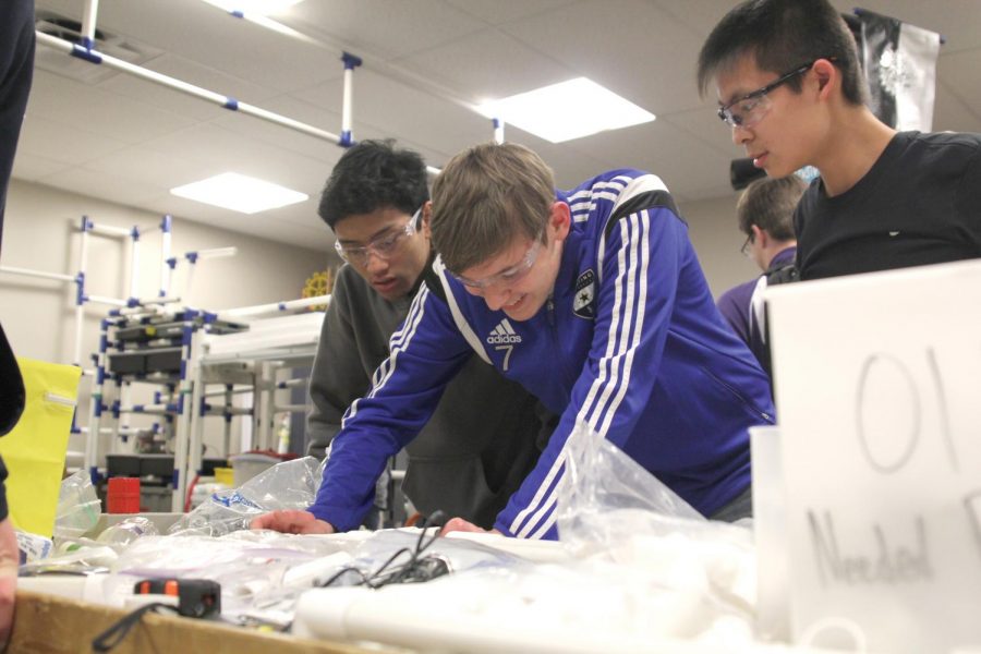 During robotics on Thursday Jan. 18, sophomores Nico Gatapia, Jacob Howe and Kevin Lee work on building a frame for the robot.  