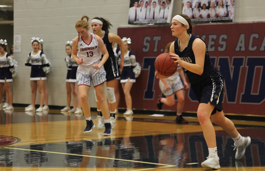 After receiving the inbound pass, junior starter Claire Kaifes runs with the ball on Friday, Feb. 2 while playing against St. James. 