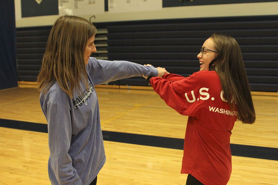 Juniors Delaney Kemp and Jessica Leininger smile as they take turns breaking out of wrist holds.
