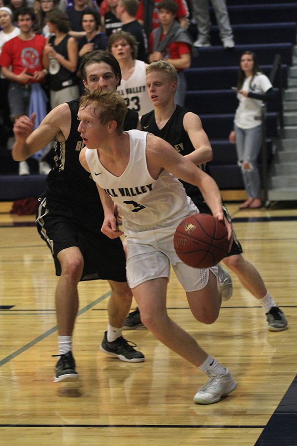 Dribbling along the baseline, senior Sammy Rebeck avoids his defender.