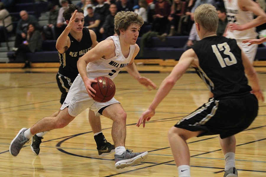 Dribbling around defenders, junior Logan Talley finds an opening to the basket. The Jaguars fell to the Blue Valley Tigers 61-47 on Friday, Feb. 23.