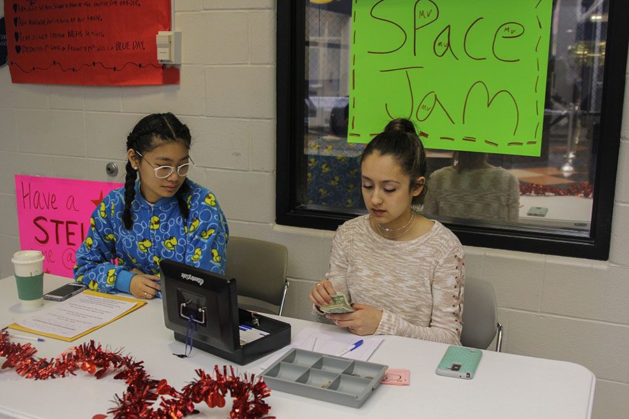 Junior Libby Mullican and ... sit by the carnation sale table and  