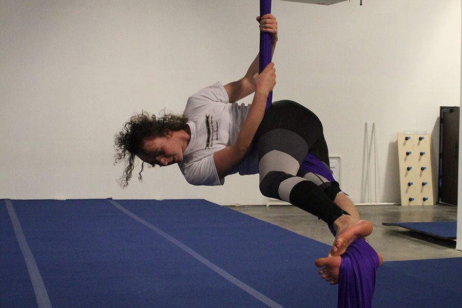 While on the silks, senior Parker Johnson looks at the floor.