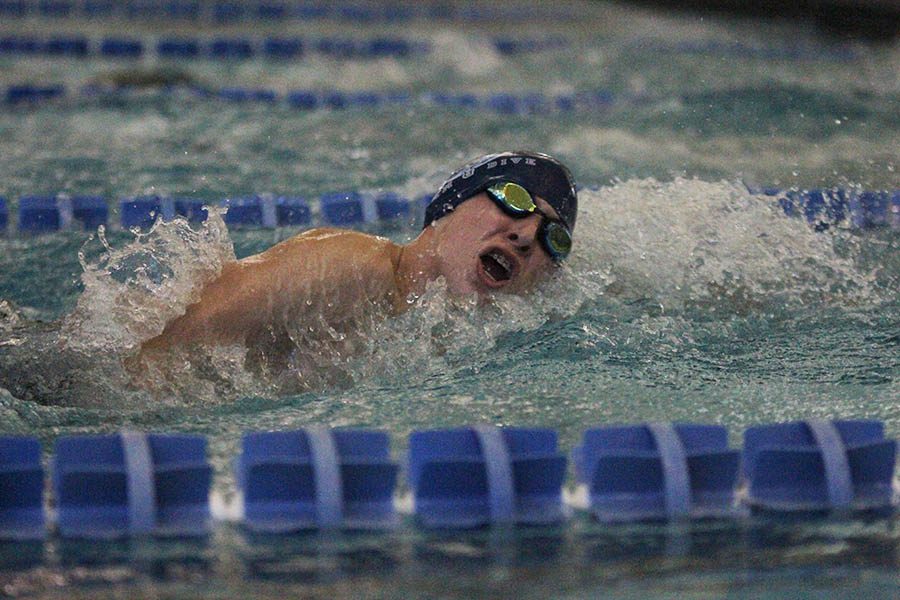 On Friday, Feb. 16, sophomore Avery Lawson swims his portion of the 400 freestyle relay.