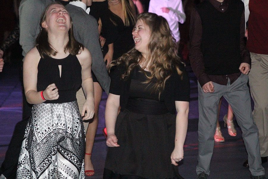 During the winter homecoming dance on Saturday, Feb. 10, sophomore Lauren ONeal and junior Lindsay ONeil laugh together while on the dance floor. 