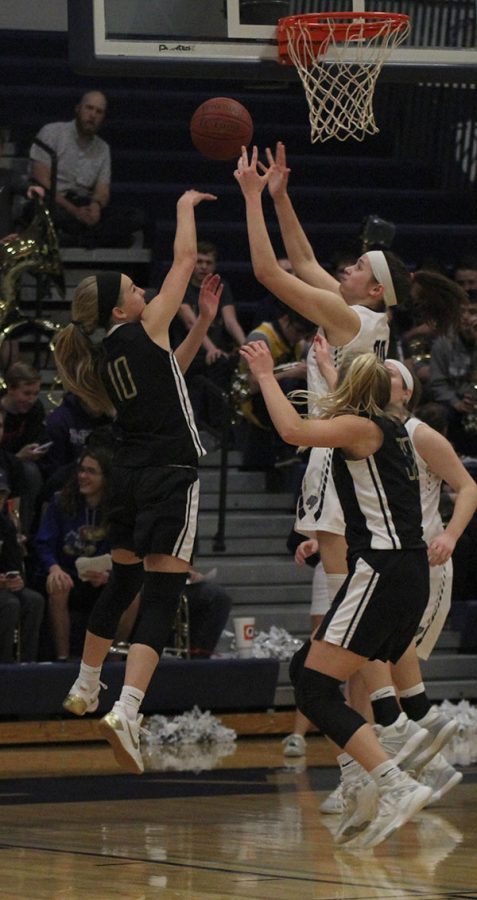 Junior Trinity Knapp reaches up to block a shot.
