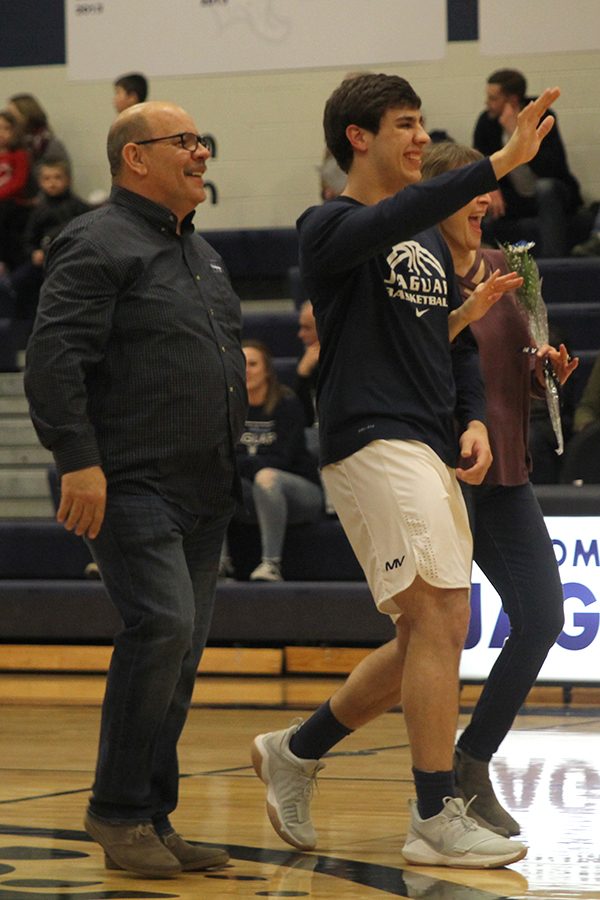 Waving to a teammate. senior Ike Valencia is recognized on senior night.