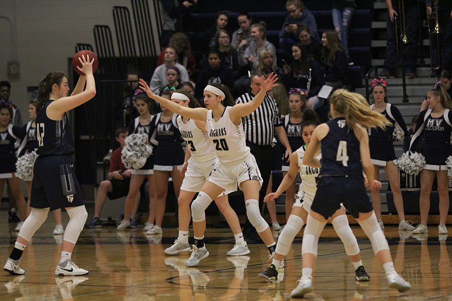 Keeping her eye on a member of the opposing team, junior Trinity Knapp plays defense on Friday, Feb. 9.