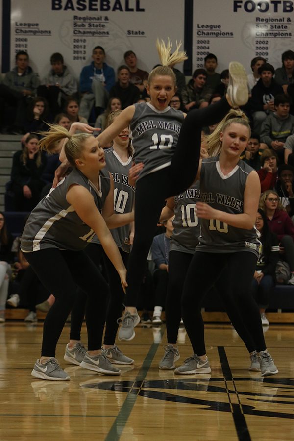 As she jumps out of her teammates arms, junior Bella Line flies through the air.