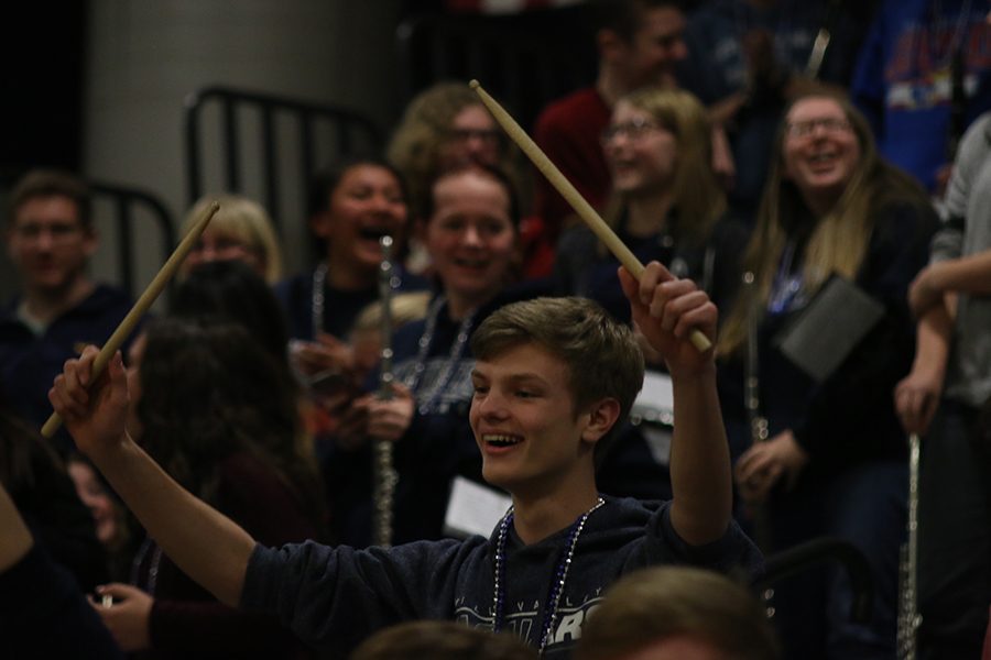 Holding his sticks in the air, freshman Leif Campbell screams during Hey, Hey, Whatdya Say?