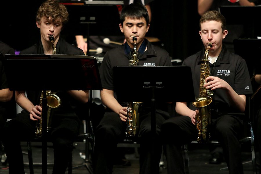 Looking at their music, freshman John Fraka, junior Tommy Tanaka and junior Kaiden Julian perform pieces selected for the annual jazz band concert on Thursday, Mar. 1.