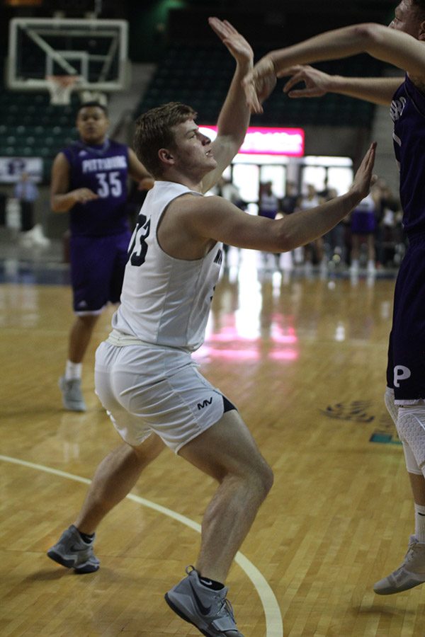 With his arms up, senior Brody Flaming attempts to block a Pittsburg pass. 