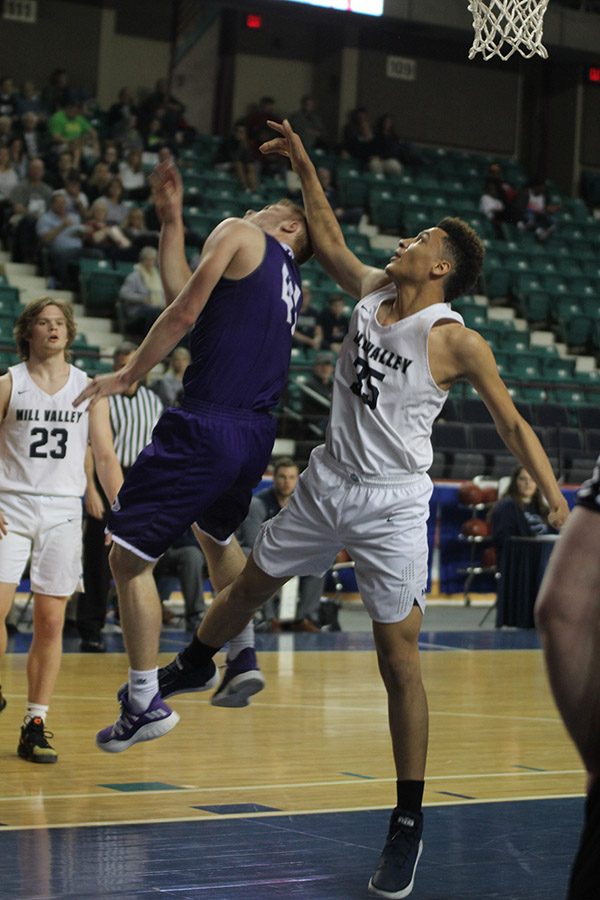 Following a shot by Pittsburg, freshman Keeshawn Mason tries to get the rebound. 