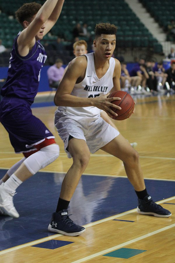 Focused on maintaining possession of the ball, freshman Keeshawn Mason prepares to take a shot. 