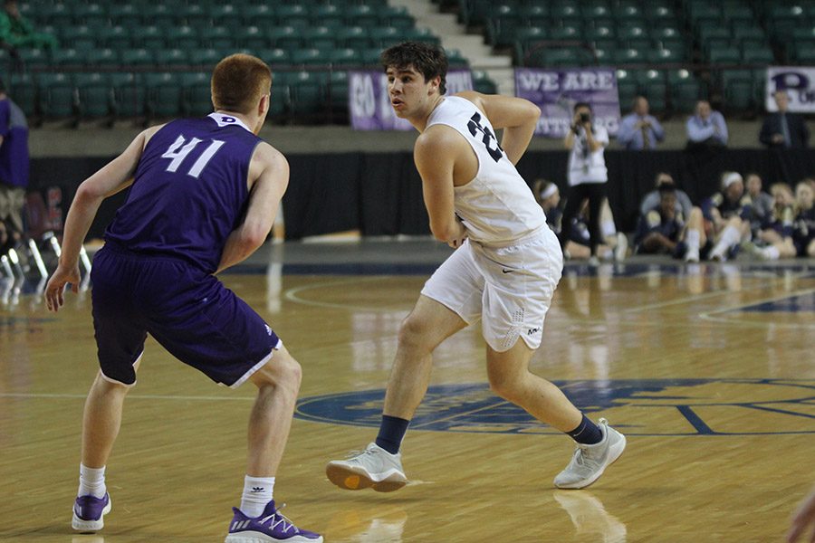 Looking for an open teammate to pass to, senior Ike Valencia keeps the ball away from a Pittsburg defender. 