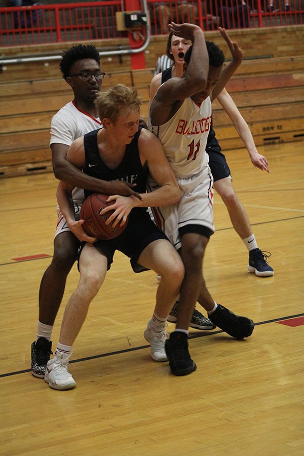 With pressure from Wyandotte defenders, senior Sammy Rebeck fights to keep the ball in posession.