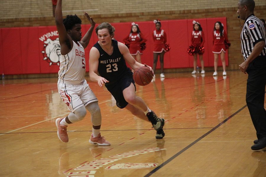 Dribbling down the court, senior Cooper Kaifes runs past a Wyandotte defender.