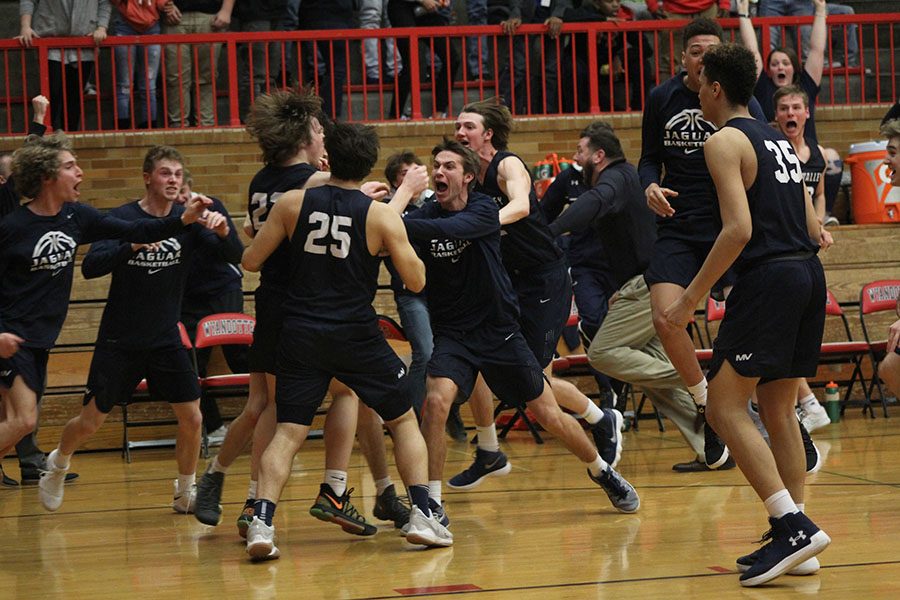 After scoring the game-winning point, senior Cooper Kaifes is met by senior Kyle Bonstetter and the rest of his teammates in celebration. 