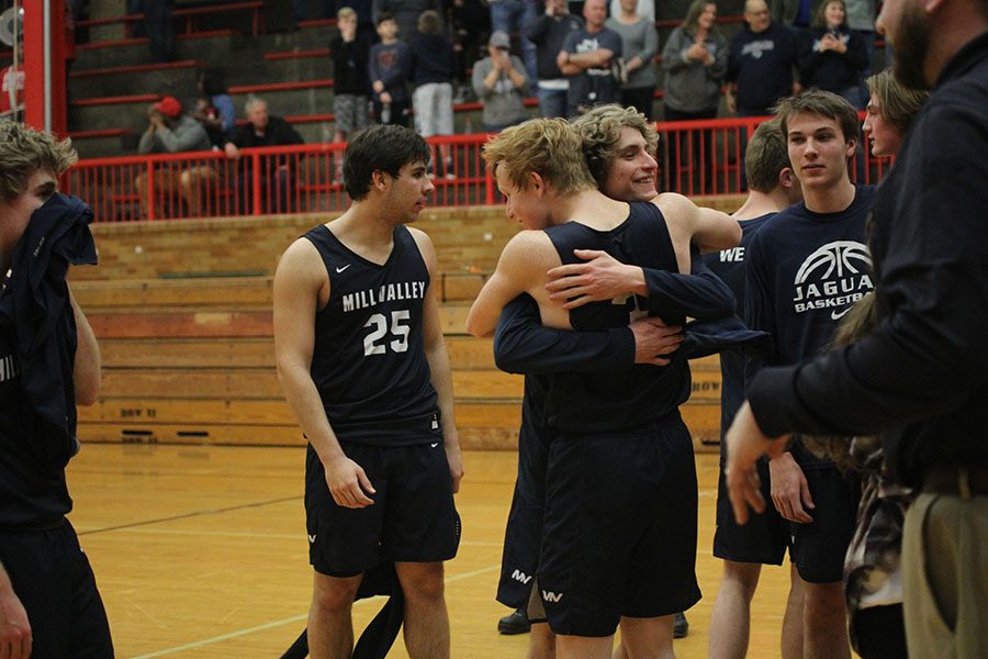 Celebrating the win, seniors Sammy Rebeck and Colton Hinkle hug. 