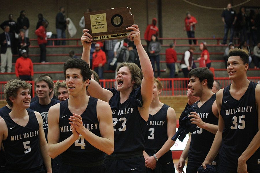 As he holds up the substate trophy, senior Cooper Kaifes celebrates with the crowd.