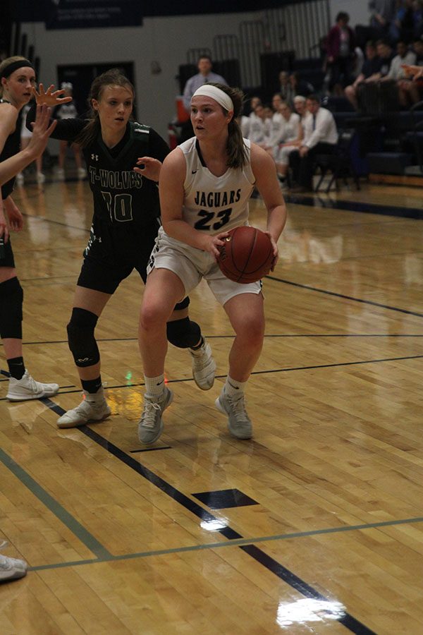 Focused on finding a teammate to pass to, junior Claire Kaifes keeps the ball away from BVSouthwest defenders. 