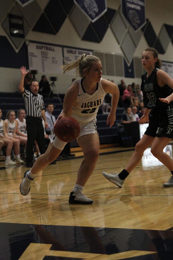 Making a move to the basket, senior Payton Shurley dribbles the ball.