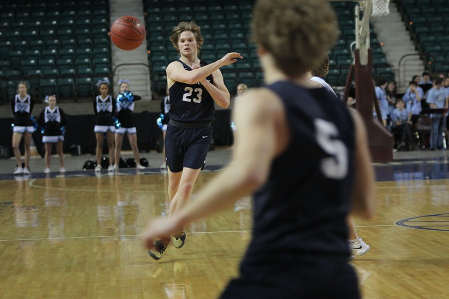 Passing the ball to junior Logan Talley, senior Cooper Kaifes focuses on his throw.