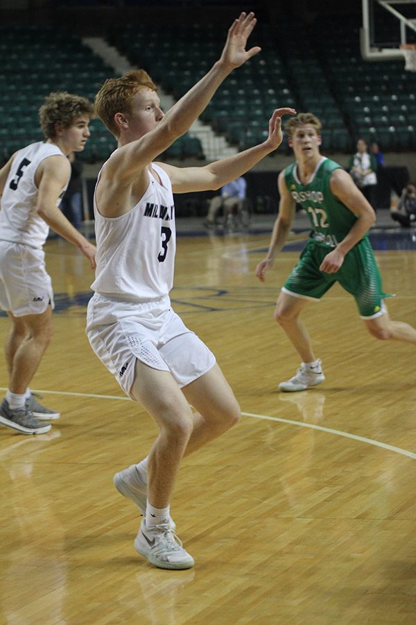 Trying to block a pass, senior Sammy Rebeck plays defense. 