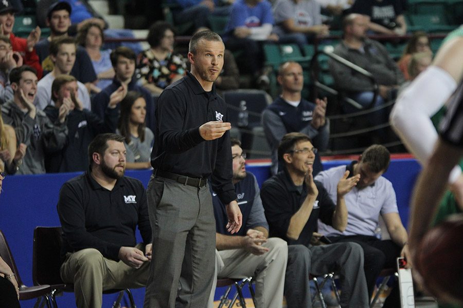 After a foul is called, head coach Mike Bennett gives advice to the players.