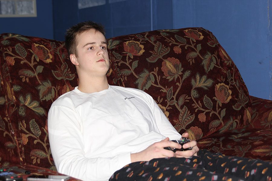 While relaxing during a day off of school, senior Brennan Schulte plays Fortnite on Sunday, Feb. 25.
