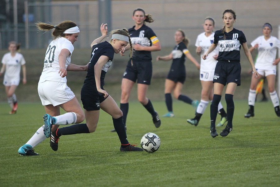 With a defender on her back, sophomore Annie Hoog turns away with the ball.
