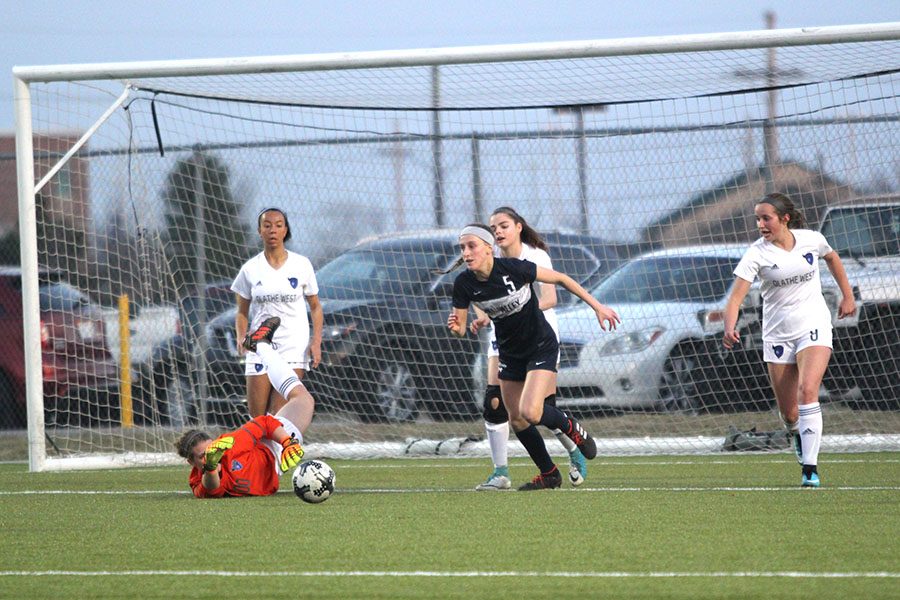 After shooting the ball, sophomore Annie Hoog looks to collect the rebound.