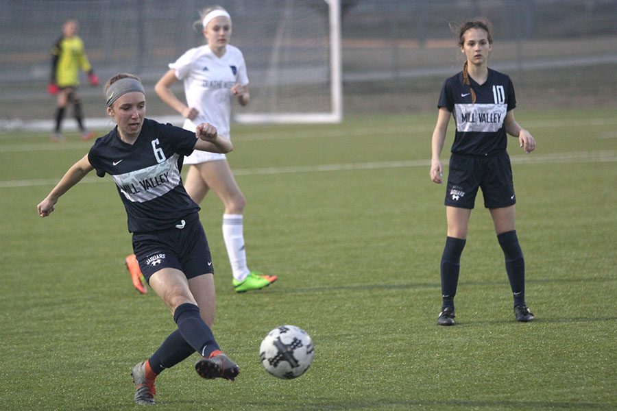 After receiving a pass, sophomore Emerson Kaiser passes the ball to a teammate.