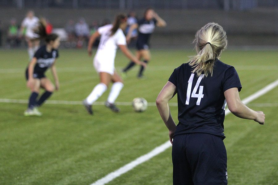 While watching the play unfold, senior Adde Hinkle moves to get into position.