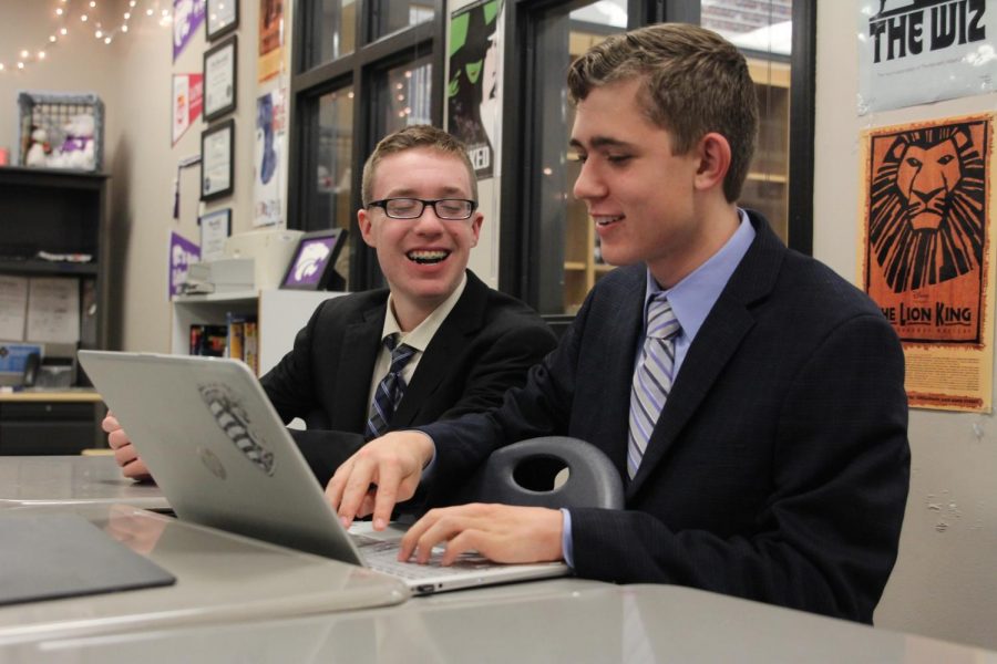 Looking at the computer, freshmen Ben Wieland and Tanner Smith converse as they prepare for their upcoming performances.