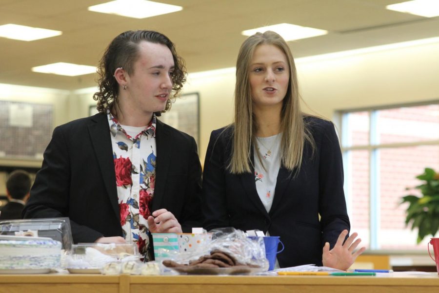 After drawing from the cup, sophomore Annie Bogart and senior Parker Johnson learn what skit they will perform in the next half hour.