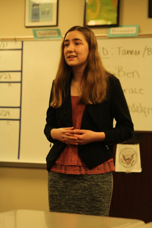 Addressing her audience, freshman Grace McLoud breaks down the science behind conspiracy theories.