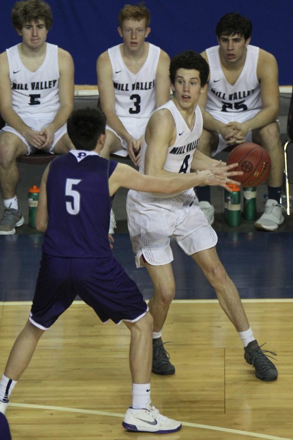 After dribbling toward the baseline, senior Mason Little picks the ball up to pass to a teammate.

