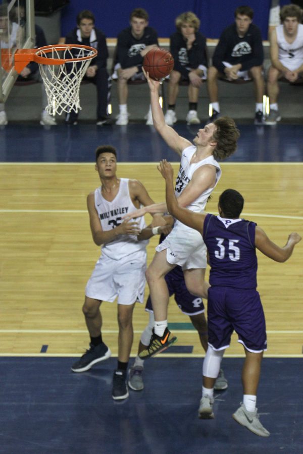 Trying to cut in Pittsburg’s lead, senior Cooper Kaifes dribbles down the lane and shoots a layup.
